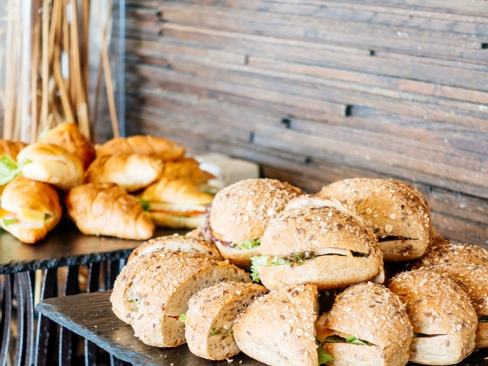 Gourmet sandwich and croissant catering spread at a Gather event
