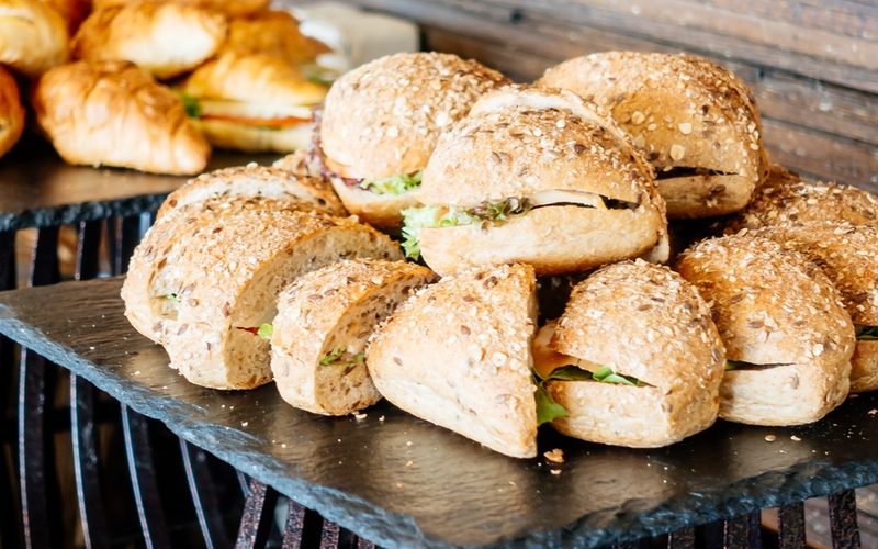 Gourmet sandwich and croissant catering spread at a Gather event